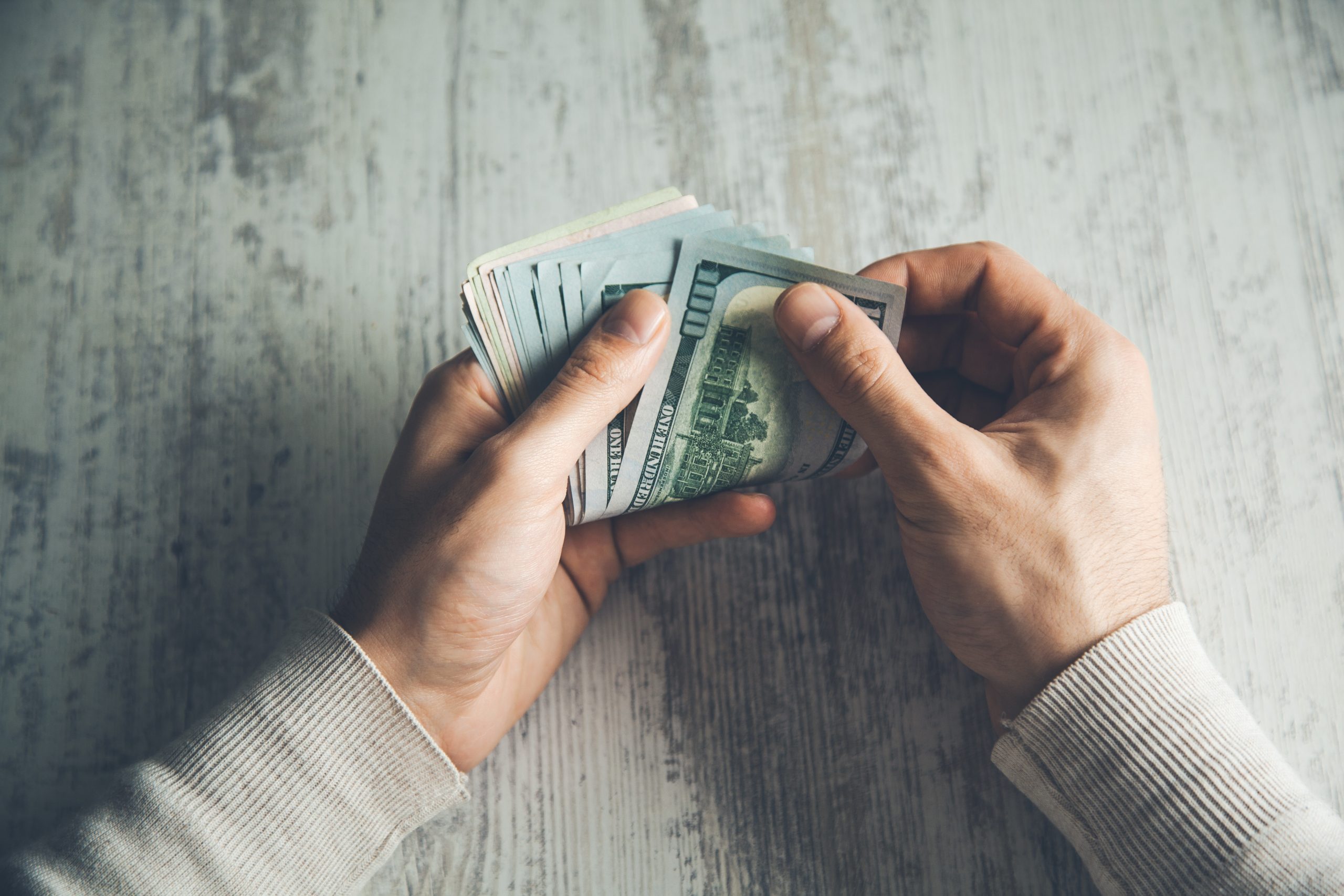 man hand money on table